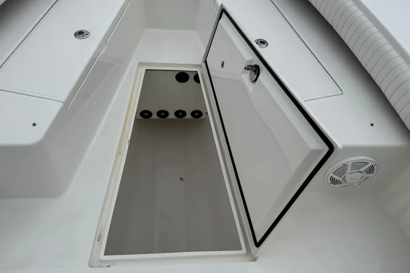 Slide: The Image of Open storage compartment on a 2007 Regulator 26 Forward Seating boat. - 15