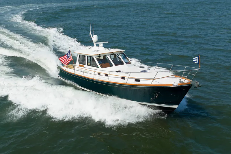 Slide: The Image of Alden 52 Salon Express 2008 cruising on open water, displaying American flag. - 56