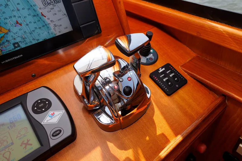 Slide: The Image of Control panel of a 2008 Alden 52 Salon Express yacht with navigation and throttle controls. - 16