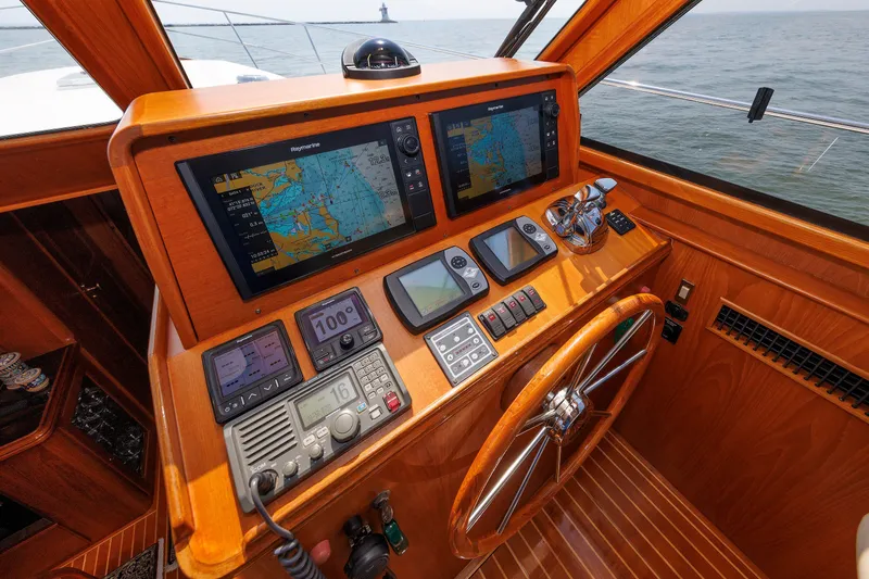 Slide: The Image of Helm of 2008 Alden 52 Salon Express with navigation screens and wooden steering wheel. - 15
