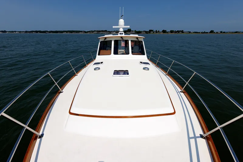 Slide: The Image of 2008 Alden 52 Salon Express yacht cruising on calm waters under clear skies. - 45
