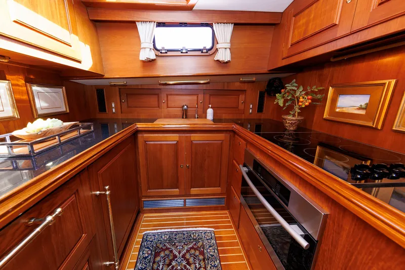 Slide: The Image of Luxurious wooden interior of 2008 Alden 52 Salon Express yacht kitchen with modern appliances. - 21