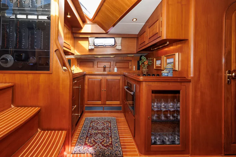 Slide: The Image of Luxurious wooden interior of 2008 Alden 52 Salon Express yacht kitchen with elegant cabinetry. - 19