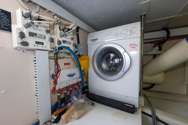 Slide: The Image of Laundry area with washing machine and control panels on a 2008 Alden 52 Salon Express yacht. - 51