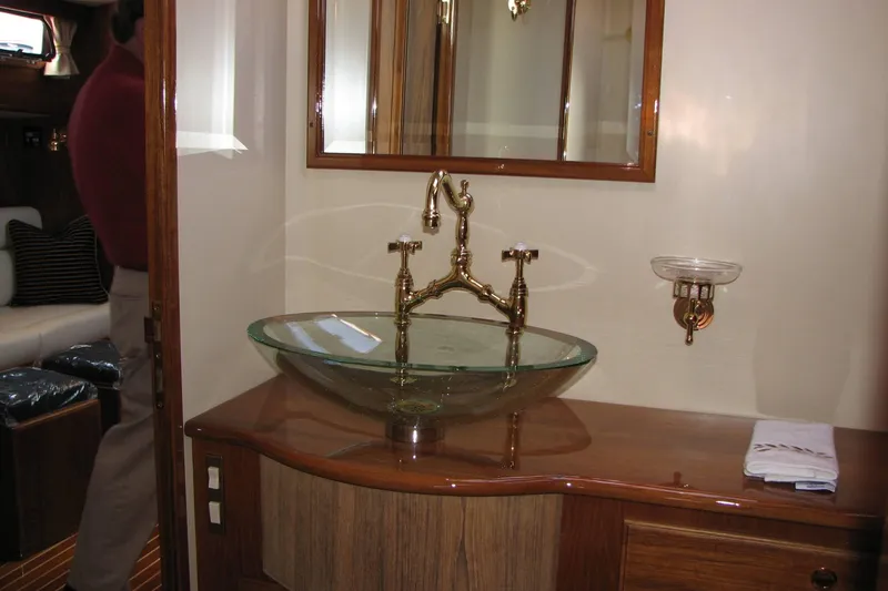 Slide: The Image of Luxurious bathroom interior of 2008 Alden 52 Salon Express yacht with glass sink and brass fixtures. - 36