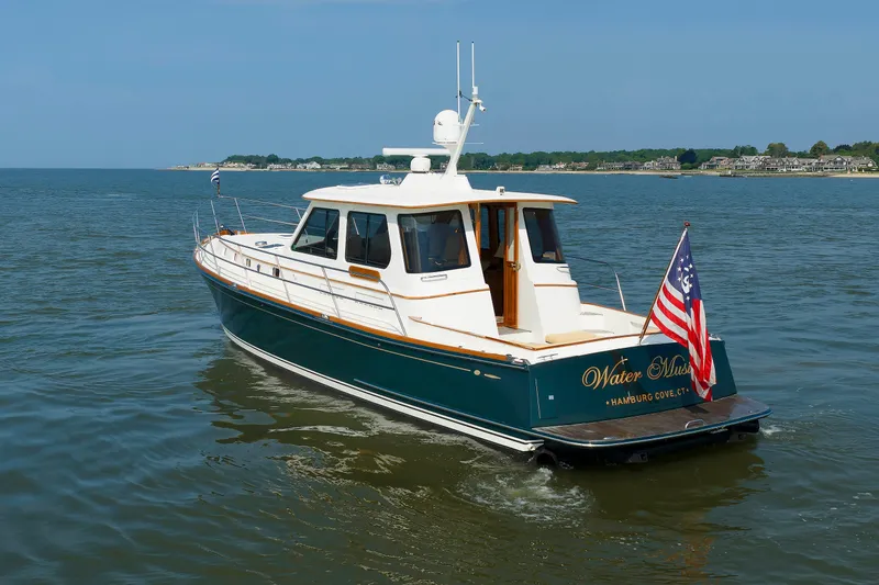 Slide: The Image of Alden 52 Salon Express 2008 yacht cruising on calm waters with American flag. - 54