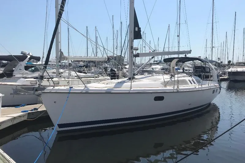 Slide: The Image of Sailboat docked in marina, 1999 Hunter 380 model, surrounded by other boats. - 1