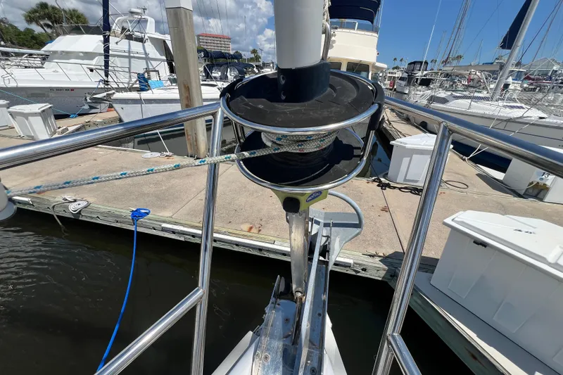 Slide: The Image of Bow of a 1999 Hunter 380 sailboat docked at a marina. - 13