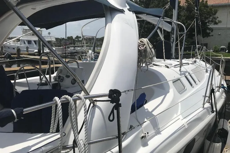 Slide: The Image of Sailboat docked at marina, Hunter 380 model, 1999, with ropes and canopy. - 2