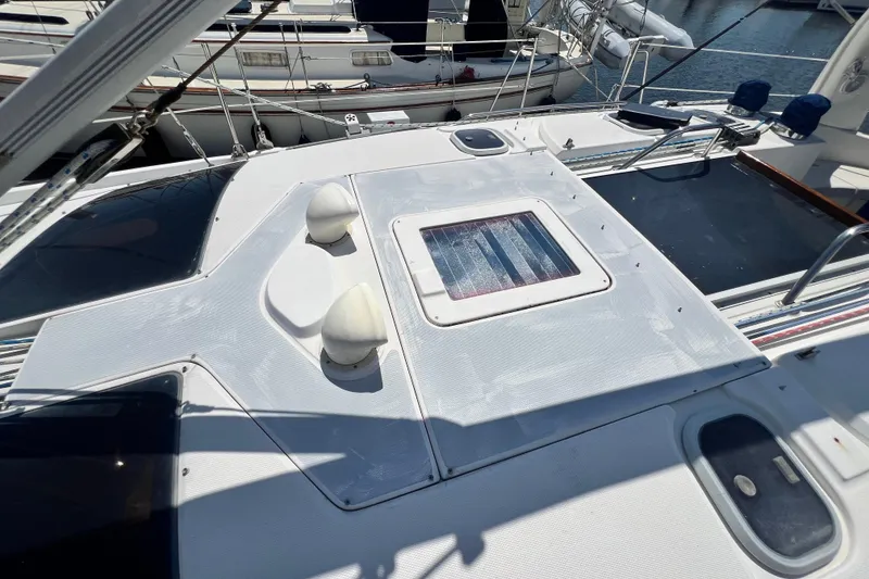 Slide: The Image of Deck view of a 1999 Hunter 380 sailboat, featuring a hatch and fittings. - 20