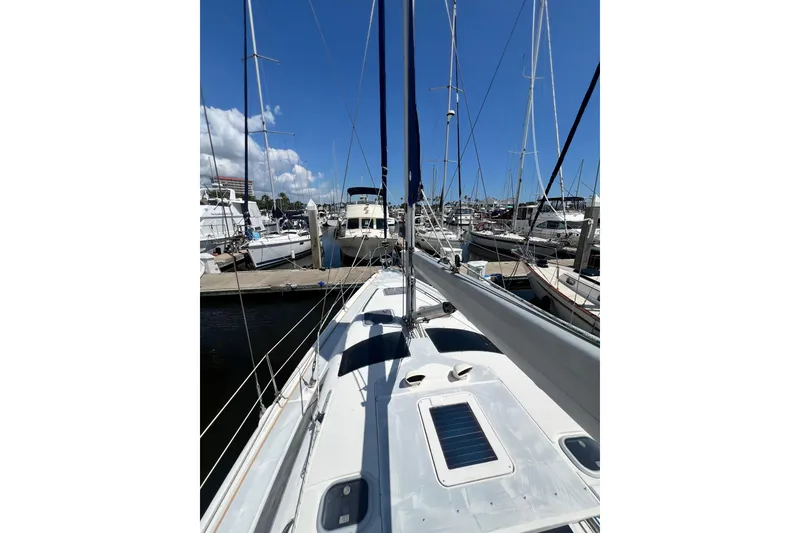Slide: The Image of Sailboat Hunter 380, 1999 model, docked at marina under clear blue sky. - 23