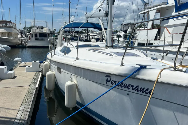 Slide: The Image of Hunter 380 sailboat named "Perseverance" docked at a marina, 1999 model. - 3