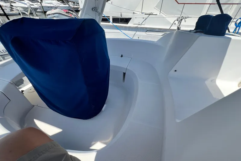 Slide: The Image of Cockpit of a 1999 Hunter 380 sailboat with blue-covered helm and seating area. - 30