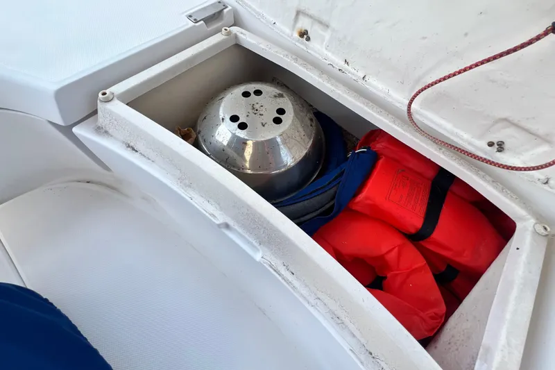 Slide: The Image of Boat storage compartment with life jackets and metal container, Hunter 380, 1999 model. - 31