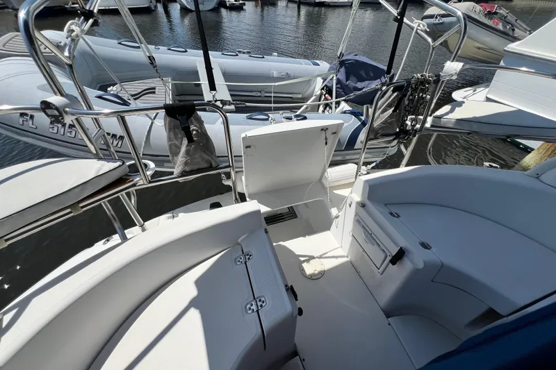 Slide: The Image of Cockpit view of a 1999 Hunter 380 sailboat docked at a marina. - 32