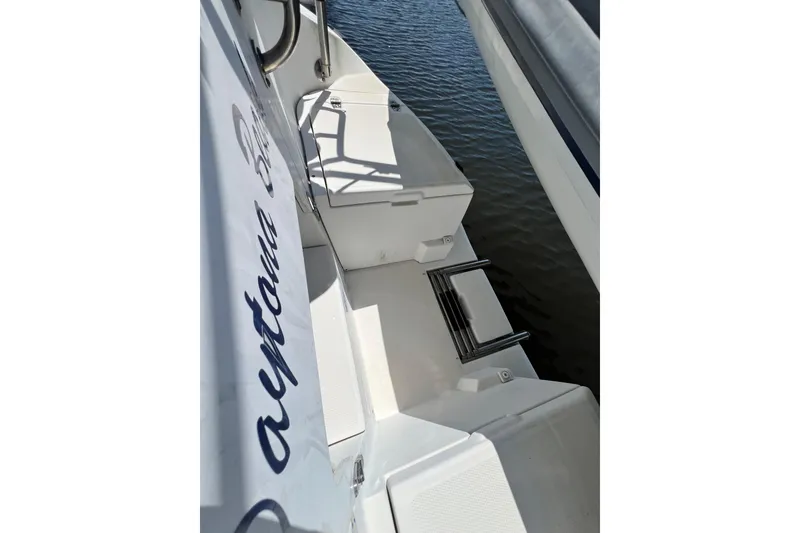 Slide: The Image of Hunter 380 sailboat deck view, 1999 model, showing seating and water reflection. - 33