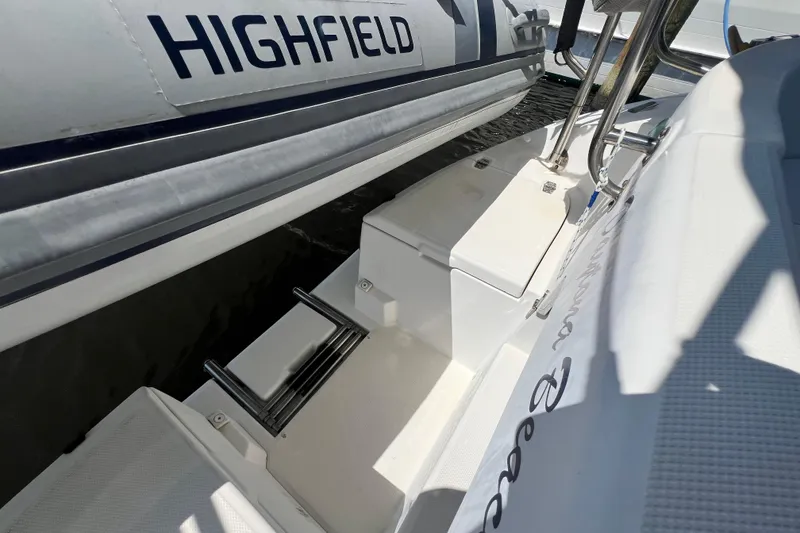 Slide: The Image of Hunter 380 yacht with Highfield inflatable boat, featuring a sleek white deck and ladder. - 34