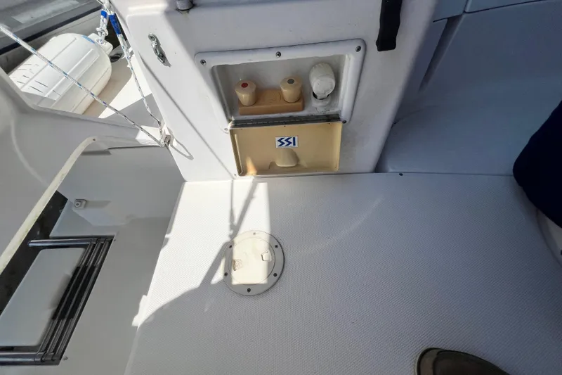 Slide: The Image of Interior view of a 1999 Hunter 380 sailboat cockpit with storage compartment. - 36