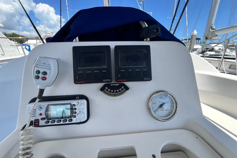 Slide: The Image of Control panel of a 1999 Hunter 380 sailboat with navigation instruments and gauges. - 37