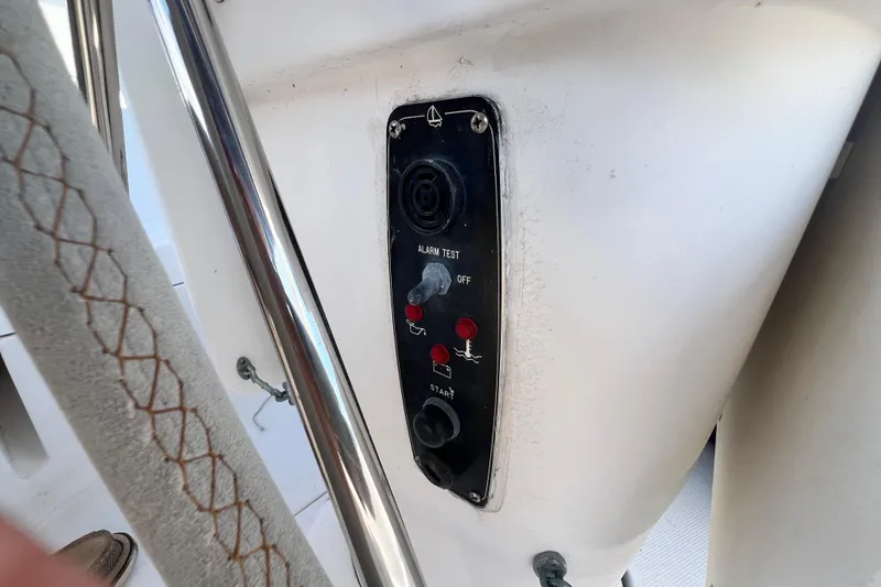 Slide: The Image of Control panel on a 1999 Hunter 380 sailboat, featuring alarm test and start buttons. - 38