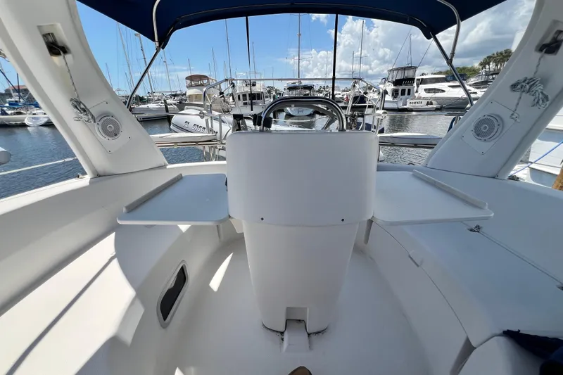 Slide: The Image of Cockpit view of a 1999 Hunter 380 sailboat docked at a marina. - 40