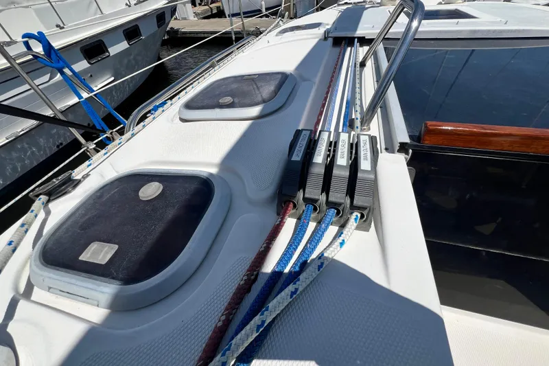 Slide: The Image of Deck of a 1999 Hunter 380 sailboat with rope clutches and hatches. - 42