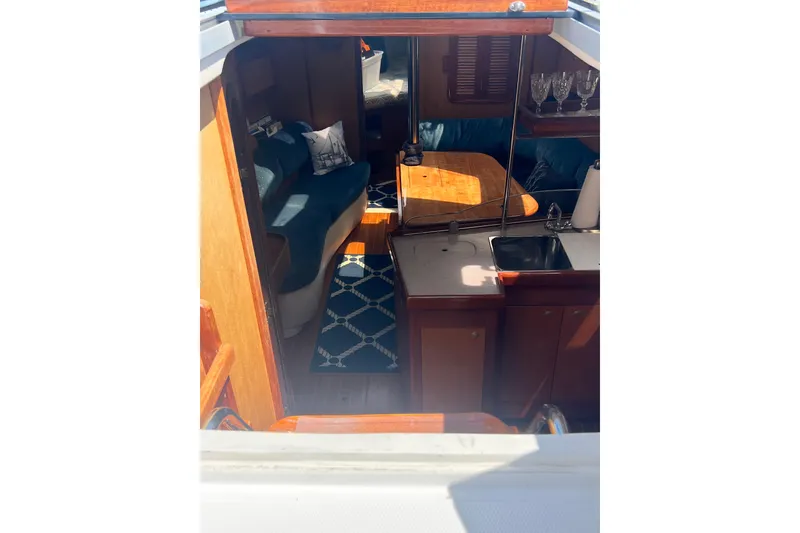 Slide: The Image of Interior of a 1999 Hunter 380 sailboat with cozy seating and kitchenette. - 44