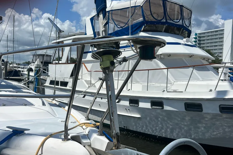 Slide: The Image of Hunter 380 sailboat from 1999 docked at a marina, surrounded by other boats. - 6