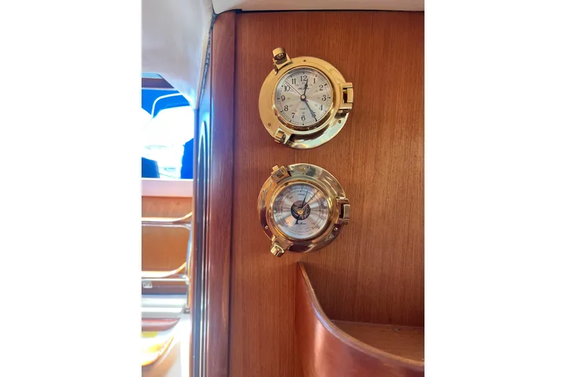 Slide: The Image of Brass clock and barometer on 1999 Hunter 380 yacht's wooden interior. - 60