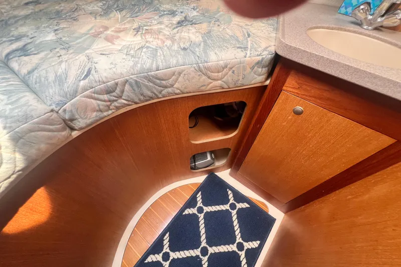 Slide: The Image of Interior of a 1999 Hunter 380 sailboat with wood cabinetry and patterned upholstery. - 61