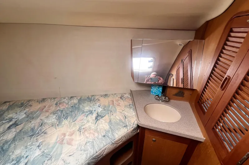 Slide: The Image of Interior of a 1999 Hunter 380 sailboat cabin with bed and sink. - 63