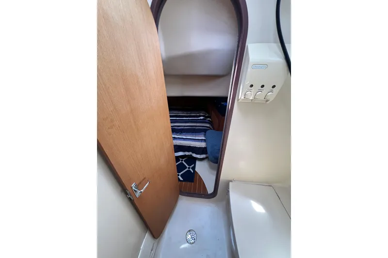 Slide: The Image of Interior cabin view of a 1999 Hunter 380 sailboat, featuring a cozy sleeping area. - 68