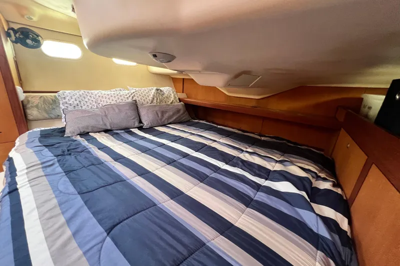Slide: The Image of Cozy cabin interior of a 1999 Hunter 380 sailboat with striped bedding. - 73