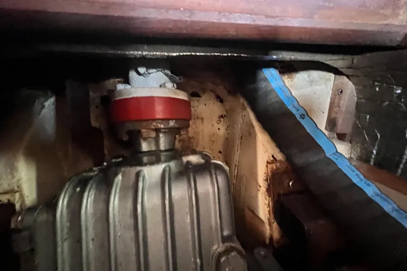 Slide: The Image of Engine compartment of a 1999 Hunter 380 sailboat, showing mechanical components and hoses. - 78
