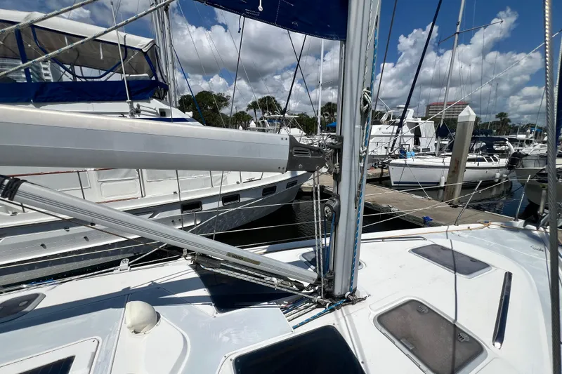 Slide: The Image of 1999 Hunter 380 sailboat docked at marina under blue sky. - 8