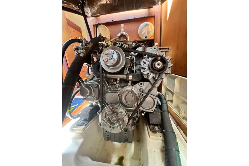 Slide: The Image of Engine of a 1999 Hunter 380 sailboat, showcasing belts and components. - 80