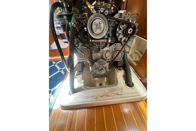Slide: The Image of Engine compartment of a 1999 Hunter 380 sailboat, showcasing mechanical components. - 81