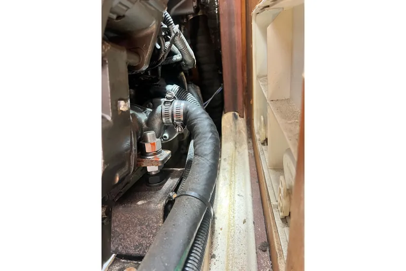 Slide: The Image of Engine compartment of a 1999 Hunter 380 sailboat, showing hoses and fittings. - 82