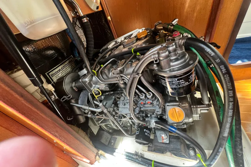 Slide: The Image of Engine compartment of a 1999 Hunter 380 sailboat, showcasing detailed mechanical components. - 84