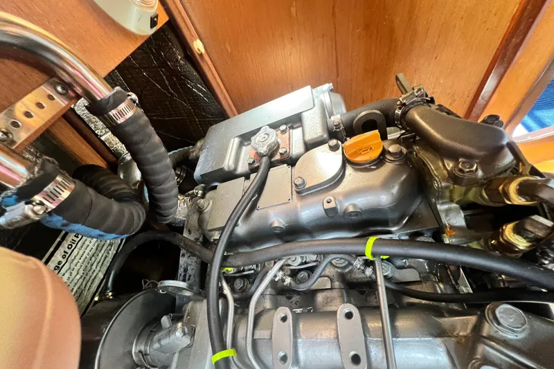 Slide: The Image of Engine compartment of a 1999 Hunter 380 sailboat, showcasing detailed mechanical components. - 85