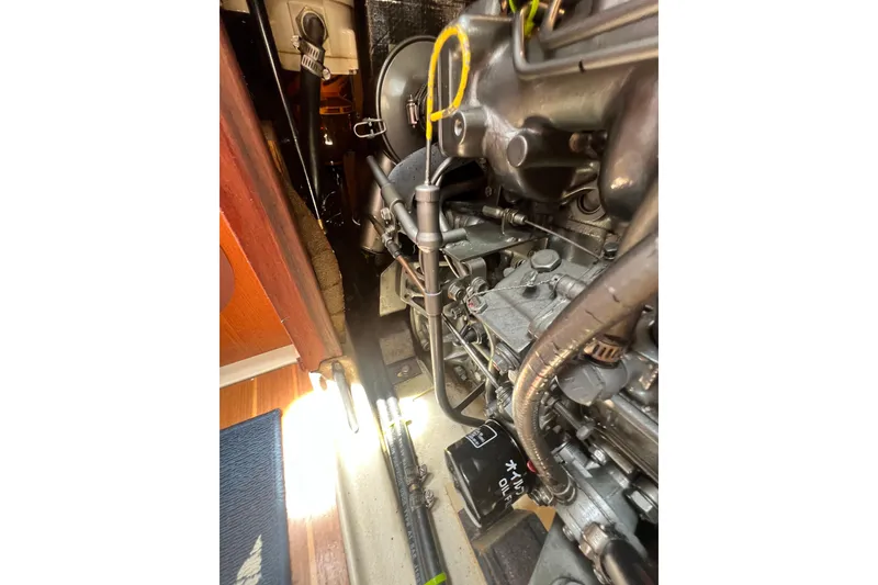 Slide: The Image of Engine compartment of a 1999 Hunter 380 sailboat, showcasing mechanical components. - 88