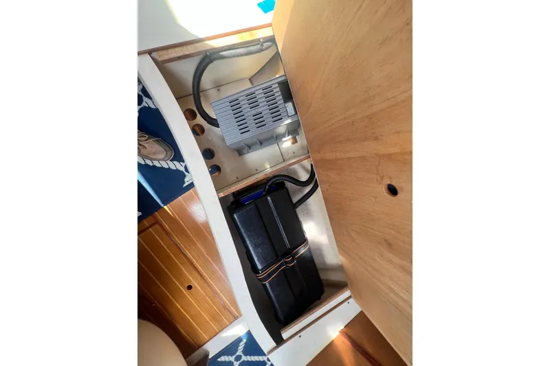 Slide: The Image of Interior view of a 1999 Hunter 380 sailboat, showcasing storage compartment details. - 90