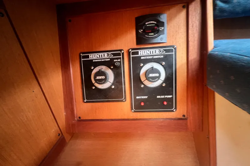 Slide: The Image of Control panel of a 1999 Hunter 380 sailboat with battery switches and bilge pump controls. - 91