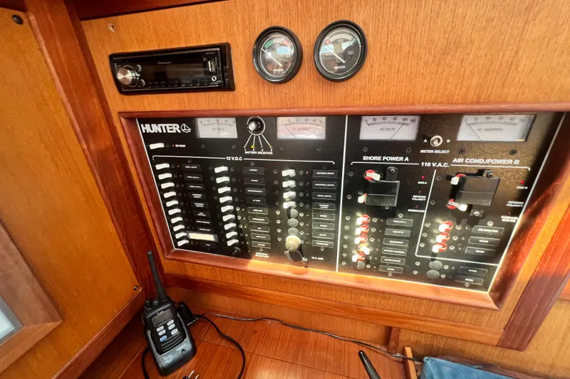 Slide: The Image of Control panel of a 1999 Hunter 380 sailboat with gauges and switches. - 92