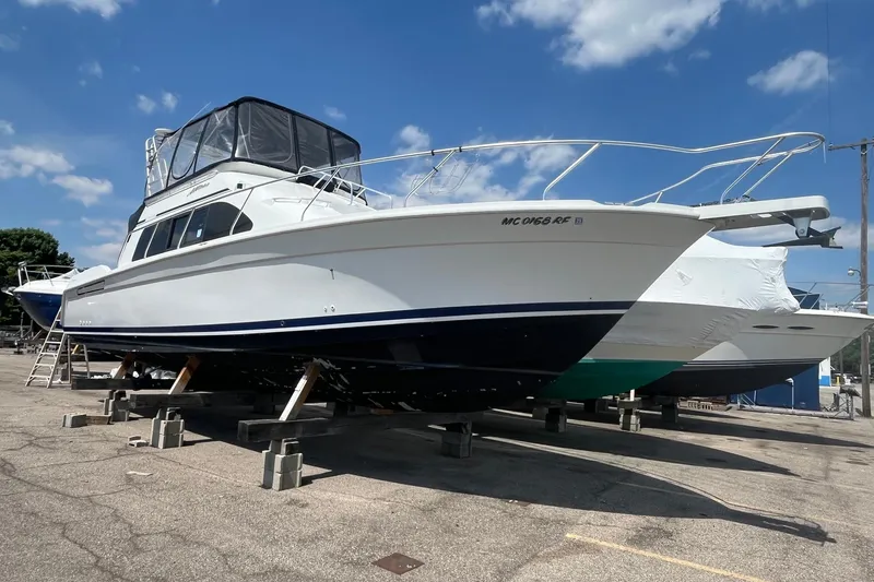 Slide: The Image of 1996 Mainship 40 Sedan Bridge yacht on dry dock under clear blue sky. - 1