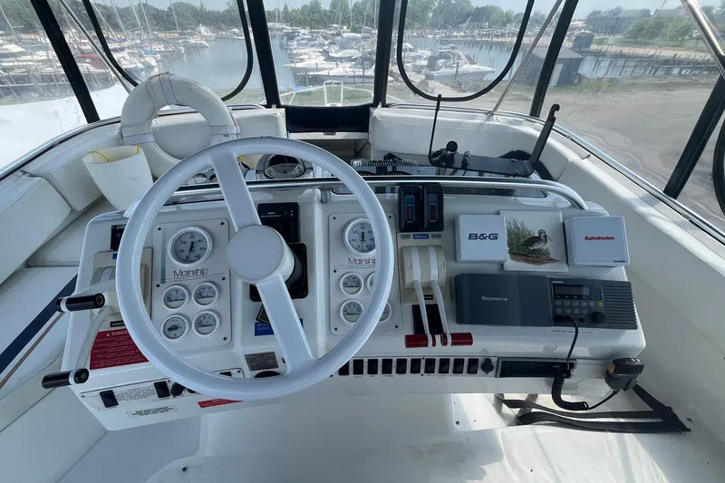 Slide: The Image of 1996 Mainship 40 Sedan Bridge helm with steering wheel and navigation instruments. - 12