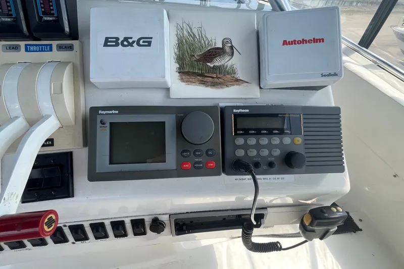 Slide: The Image of Control panel of a 1996 Mainship 40 Sedan Bridge with navigation equipment. - 13