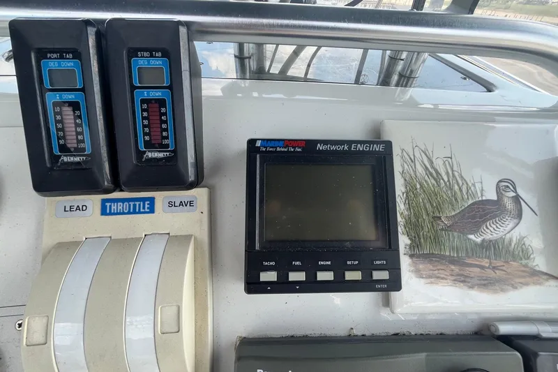 Slide: The Image of Control panel of a 1996 Mainship 40 Sedan Bridge with throttle and engine display. - 15