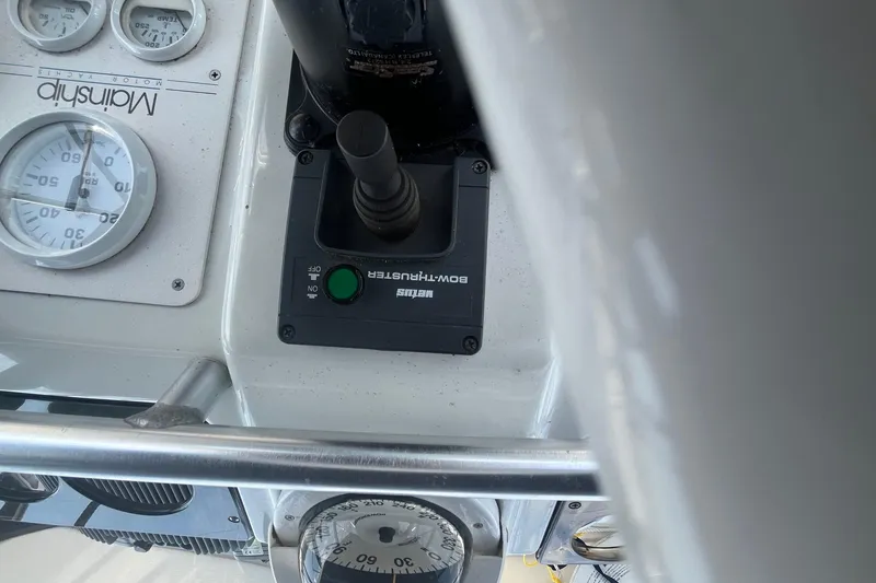 Slide: The Image of Control panel of a 1996 Mainship 40 Sedan Bridge with gauges and bow thruster. - 16