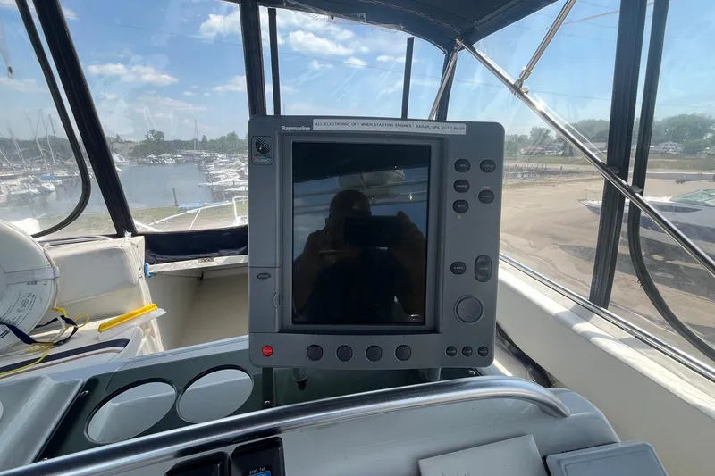 Slide: The Image of 1996 Mainship 40 Sedan Bridge helm with Raymarine navigation system, overlooking marina. - 17